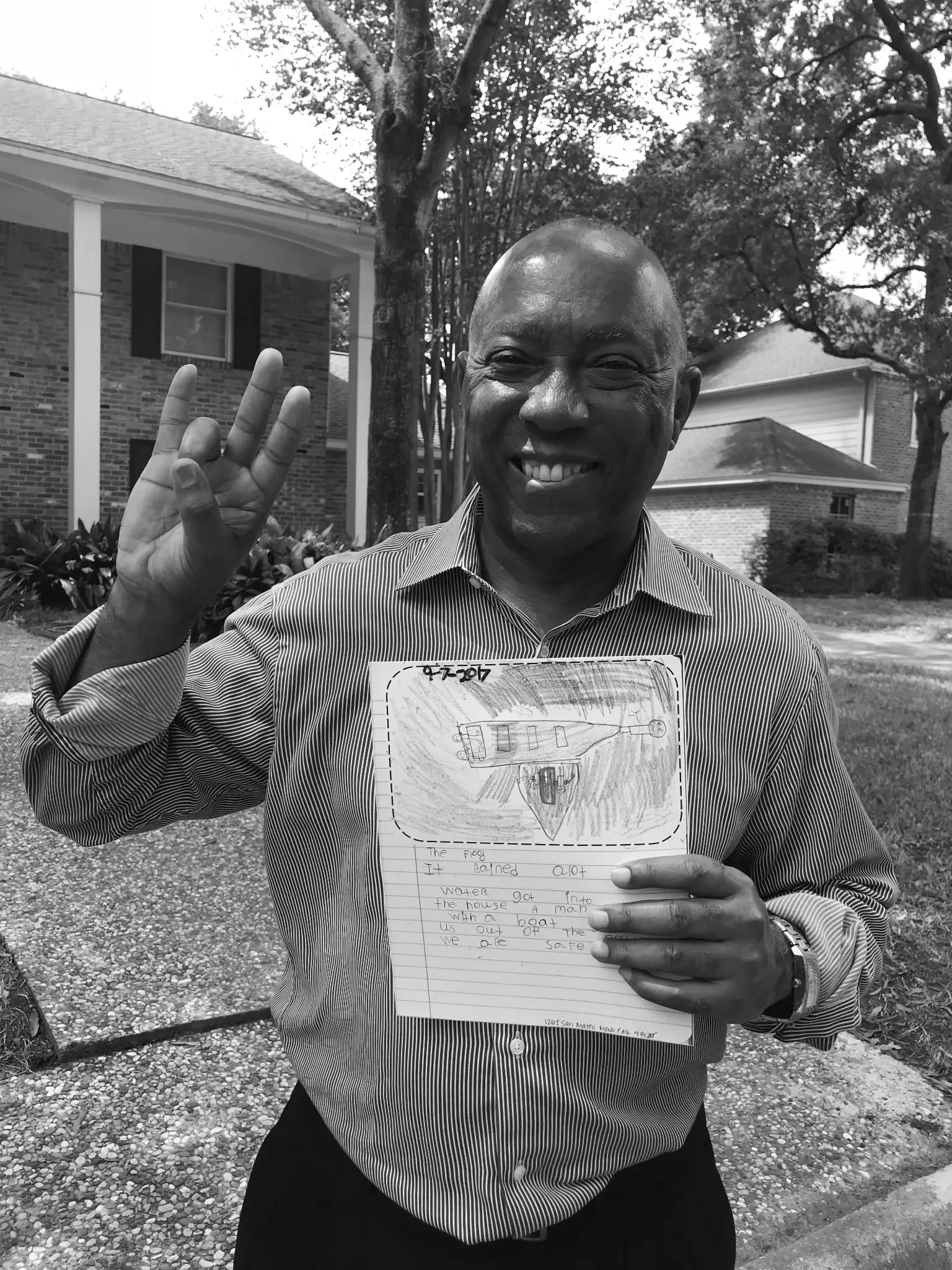 Mayor Sylvester Turner on Katie's lawn, holding Ally's thank-you drawing of the Harvey rescue — September 2018